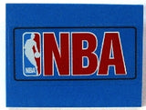 Blue LEGO Slope 10 6x8 brick with a sticker featuring the red NBA logo and white player silhouette.