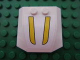 White LEGO 4x4x2/3 triple curved wedge part with a sticker showing two vertical yellow stripes, on a green studded baseplate.