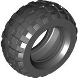 A dark gray LEGO tire with a chunky, blocky tread pattern, typical of a balloon tire, shown from an angled perspective.
