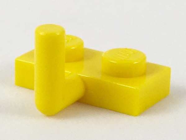 A single yellow LEGO 1x2 modified plate featuring an L-shaped bar arm extending upwards.