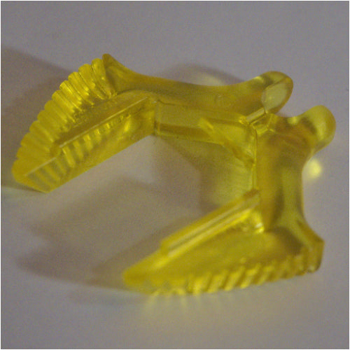Close-up of a yellow, transparent LEGO Electric Train Light Prism 4x4 part, showing its L-shape and ridged ends.