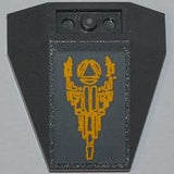Dark gray LEGO 4x4 triple inverted wedge with a sticker of a yellow Atlantis logo and stone pattern.