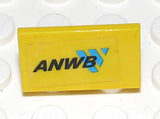 A yellow LEGO 1x2x1 panel with an ANWB sticker, featuring black text and a blue arrow logo.