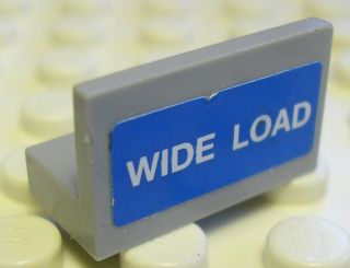 Grey LEGO Panel 1x2x1 part 4865pb034 with a blue sticker displaying white 'WIDE LOAD' text.