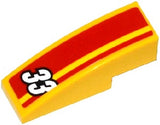 Yellow LEGO curved 3x1 slope brick with red and yellow stripes pattern and white number 33.