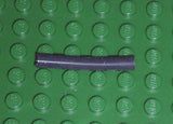 A dark gray LEGO 5102c04 pneumatic hose, 4mm diameter, 3.2cm long, on a green studded baseplate.