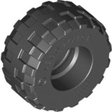 Dark grey LEGO tire 56890, with a blocky tread pattern, showing 'LEGO 24x12 R' molded on its sidewall.