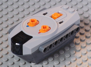 LEGO 58122c01 Electric Power Functions 9V Remote Control Unit, light gray with dark bluish gray bottom and orange knobs.