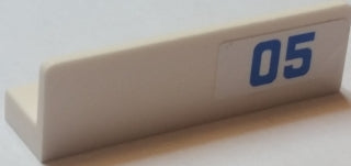 Light tan LEGO Panel 1 x 4 x 1 with a blue '05' on a white sticker, showing the model's left side.