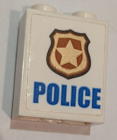 White LEGO 1x2x2 brick with inside stud holder, featuring blue 'POLICE' text and a gold and copper badge sticker.