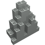 Grey LEGO 6083 Rock Panel, 3x8x7 triangular, with studs visible on the top and sides of its stepped structure.