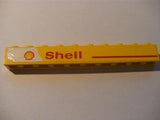 Yellow LEGO 1x10 brick with a red line and 'Shell' text and logo pattern on the left.