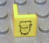 Yellow LEGO 1x1x1 corner panel with a black Frankenstein monster head pattern.