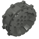 Dark gray LEGO 64711 hard plastic wheel with small cleats on the outer edge and multiple Technic pin holes.