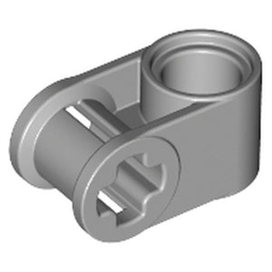 A light grey LEGO Technic Axle and Pin Connector Perpendicular (part 6536) on a white background, viewed from an angle.