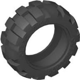 Angled view of a dark gray LEGO tire, part 6581, with a 20x30 balloon medium size and a robust block tread pattern.