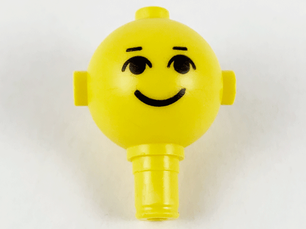 Yellow LEGO Homemaker/Maxifigure Head 685px4, with black eyes, eyebrows, and a printed smile, against a white background.