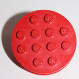 Red round LEGO 715a wheel with 12 studs, each bearing the LEGO logo, on a white background.