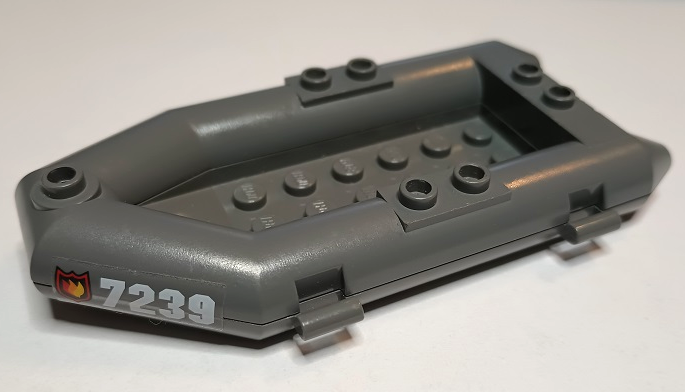 Dark gray LEGO rubber raft boat with fire logo badge and '7239' sticker on the side.