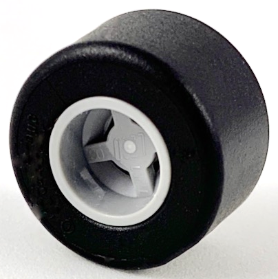 Black LEGO tire mounted on a light gray wheel hub with a notched center hole, viewed at an angle.