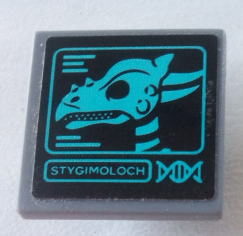 LEGO 2x2 tile with black background and a teal graphic of a Stygimoloch skull, 'STYGIMOLOCH' text, and DNA symbol.