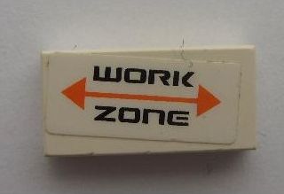 White LEGO 1x2 tile with a sticker displaying 'WORK ZONE' in black text and an orange double-headed arrow.