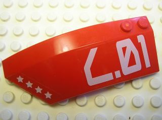 Red LEGO Wedge 8 x 3 x 2 Open Left piece with white stars and 'L.01' pattern on a white studded background.