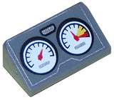 Dark gray LEGO Slope 30 1x2x2/3 brick with two white-faced gauges, one showing a red danger zone, and a silver outline print.