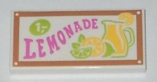 White LEGO 2x4 tile with a brown border and 'LEMONADE' pattern. Features pink text, '1,-' price, a lemonade pitcher, and citrus slices.