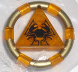 Gold ring with orange transparent segments and a central orange triangle featuring a black crab symbol. LEGO piece.