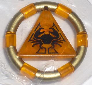 Gold ring with orange transparent segments and a central orange triangle featuring a black crab symbol. LEGO piece.