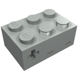 Light gray LEGO 879 Electric Touch Sensor brick with 6 studs on top, side slots, and a cross-shaped hole.