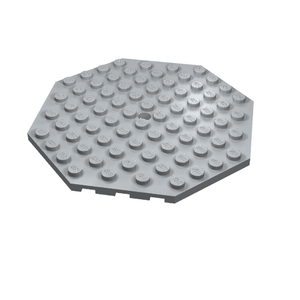 Light gray LEGO 89523 Plate, Modified 10 x 10 Octagonal with Hole, shown at an angle.