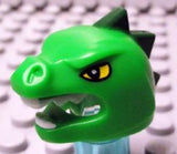 Green LEGO lizard head cover (part 95322pb01) with yellow eyes, white teeth, and dark green spikes.