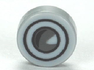 Round, light grey LEGO 1x1 tile with a black and white headlight pattern: concentric rings and a central white crescent shape.