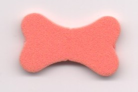 A coral-colored, bone-shaped foam LEGO Scala element with a soft texture, set against a plain white background.