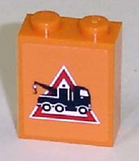 Orange LEGO 1x2x2 brick with a white-bordered red triangle danger sign pattern, showing a black tow truck with a hook.
