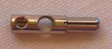Close-up of a metallic LEGO electric connector pin, long, with a cross-cut end, a round silver button, and a hole revealing a screw.