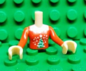 LEGO mini doll girl red torso with white dots and green Christmas tree pattern, red sleeves, and light nougat hands.