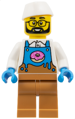 LEGO minifigure, male donut vendor with beard, glasses, white cap, blue and brown apron with a donut, white shirt, and brown legs.