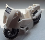 A white LEGO police motorcycle with 'POLICE' sticker on the front fairing, black wheels, and a light gray exhaust.