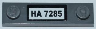 Gray LEGO 1x4 modified plate with two studs and a white label displaying 'HA 7285'.