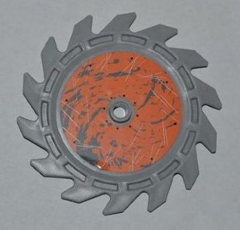 LEGO Technic 9x9 circular saw blade, gray, with an orange center, black splatter, and scratches.