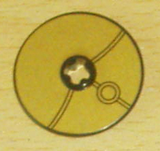 LEGO Technic Disk 3x3, gold with black lines pattern, a central stud, and a double-ring design.
