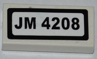 White LEGO 1x2 tile with a sticker featuring 'JM 4208' in black text and a black border.