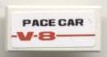 White LEGO 1x2 tile with 'PACE CAR' in black text and red '-V-8-' sticker pattern, from set 8121.