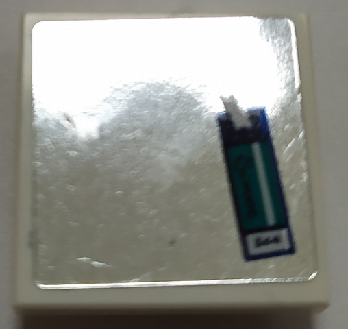 LEGO 2x2 inverted tile with mirror surface and a blue and green sticker featuring a 'SIMONE' name tag.