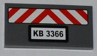 Dark gray LEGO 2x4 tile with red and white chevron danger stripes and a 'KB 3366' license plate sticker.