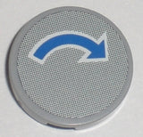 Light bluish gray LEGO round 2x2 tile with a blue curved arrow with white outline pattern on a gray dotted background.