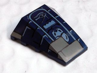 Dark blue LEGO 4x4 triple curved wedge with dark tan bricks and light bluish gray Eye of Horus, LEGO brick, and scarab hieroglyphs.